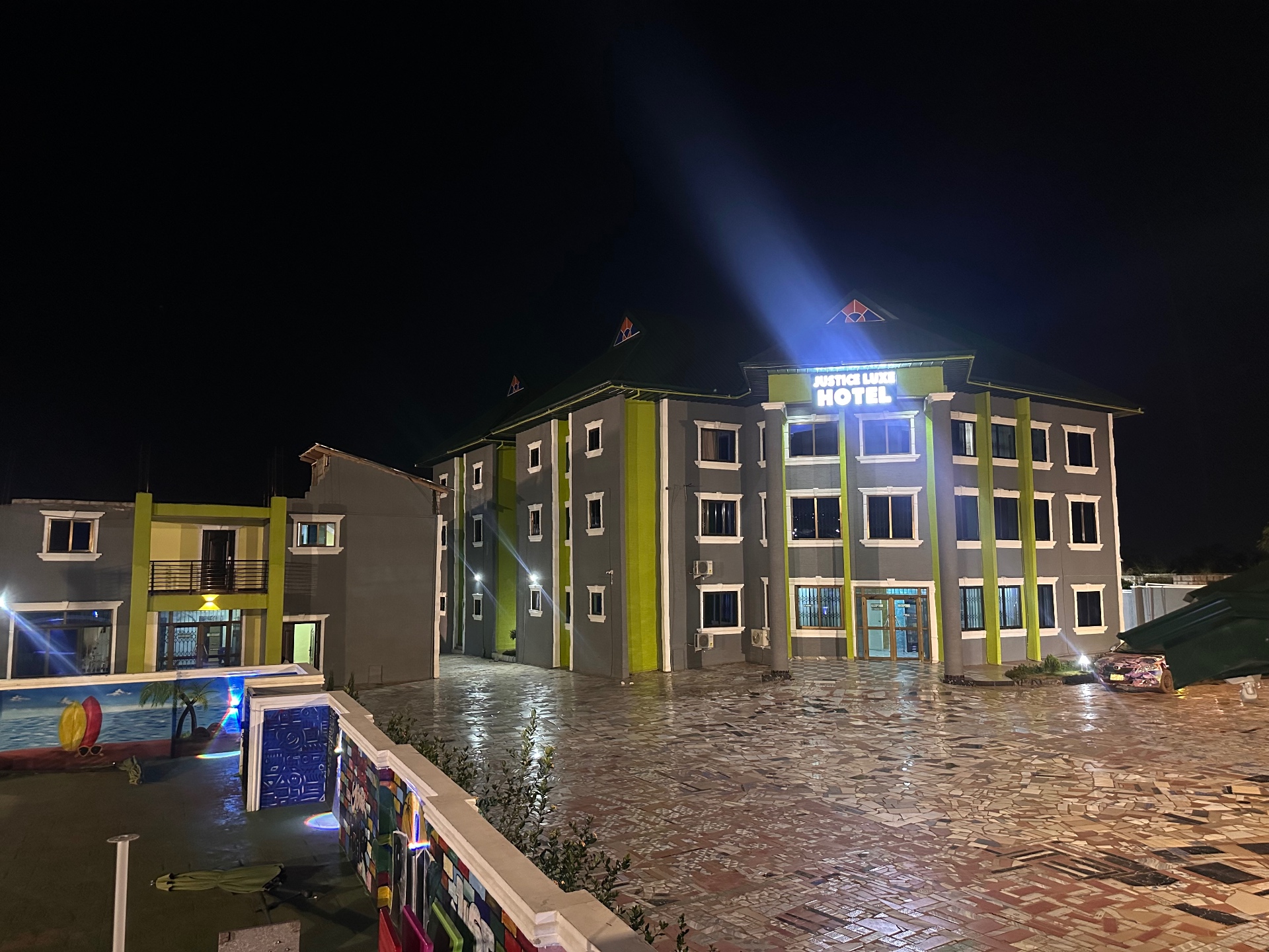 Justice Luxe Serenity Hotel illuminated at night